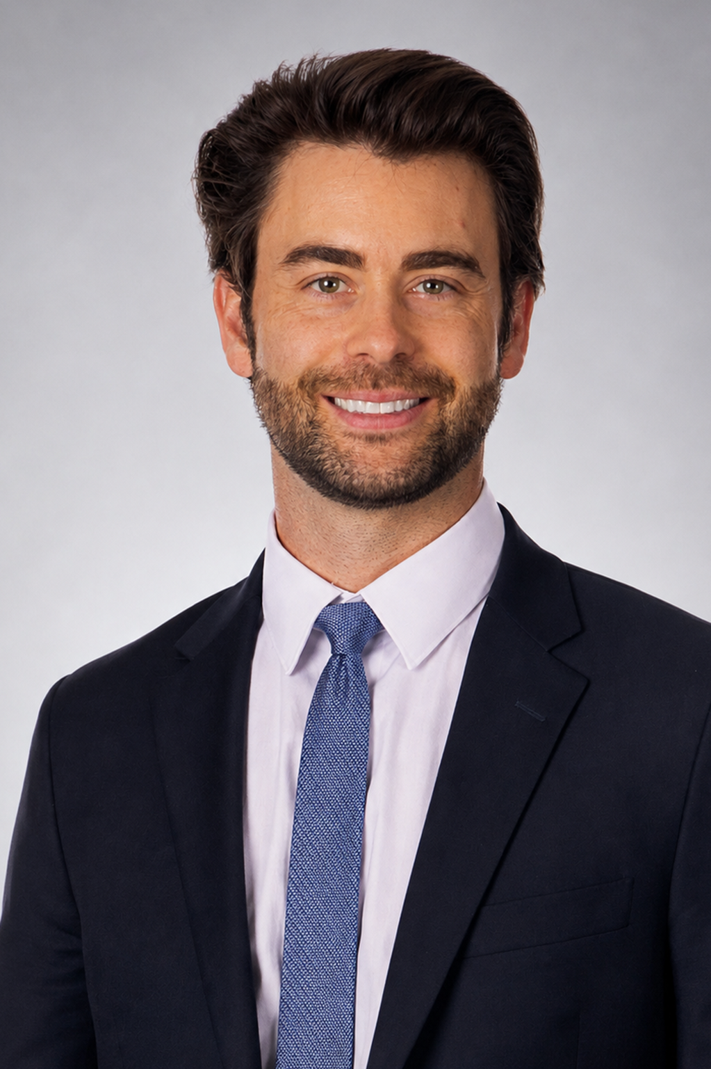 Young professional man in a navy suit and blue tie