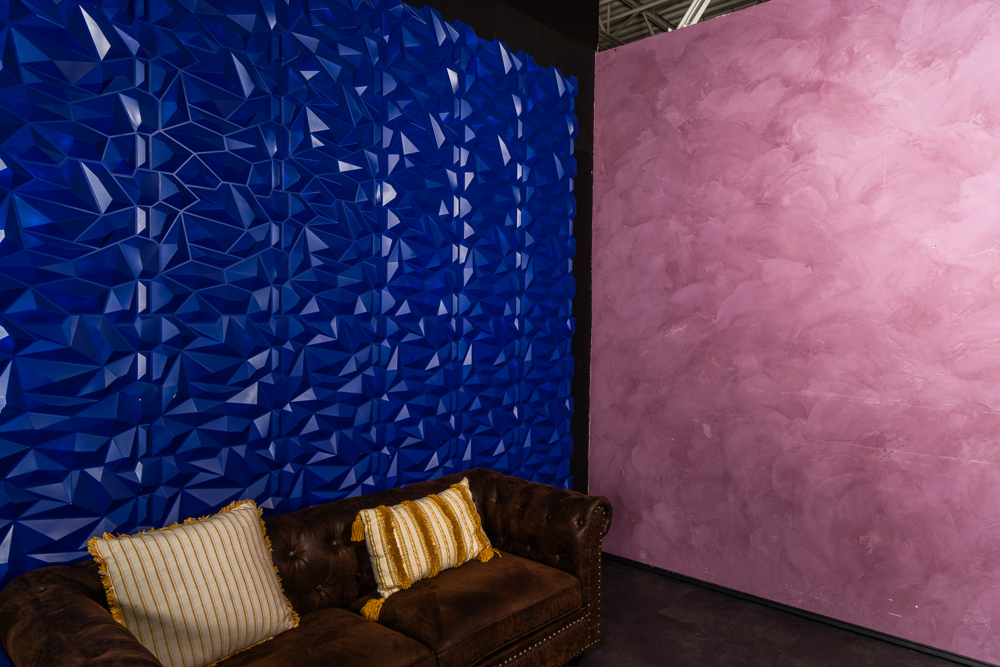 Cobalt faceted wall beside a soft rose plaster backdrop