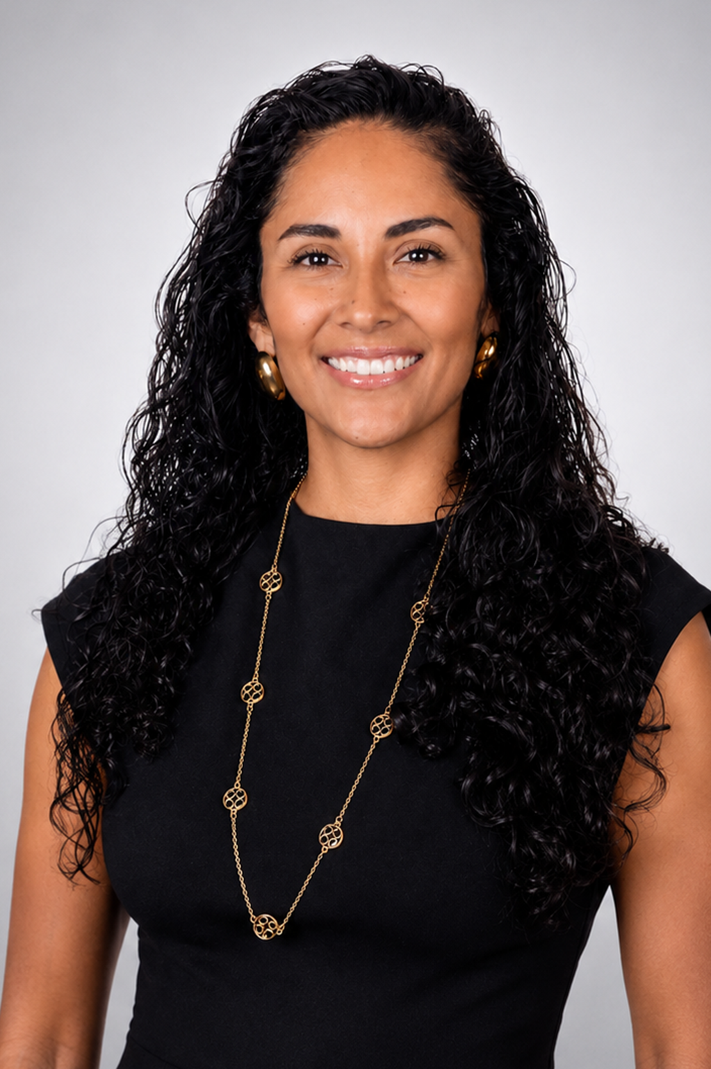 Businesswoman with curly dark hair in a black dress