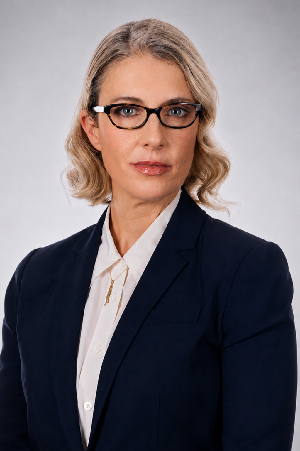 Executive woman with glasses in a navy blazer