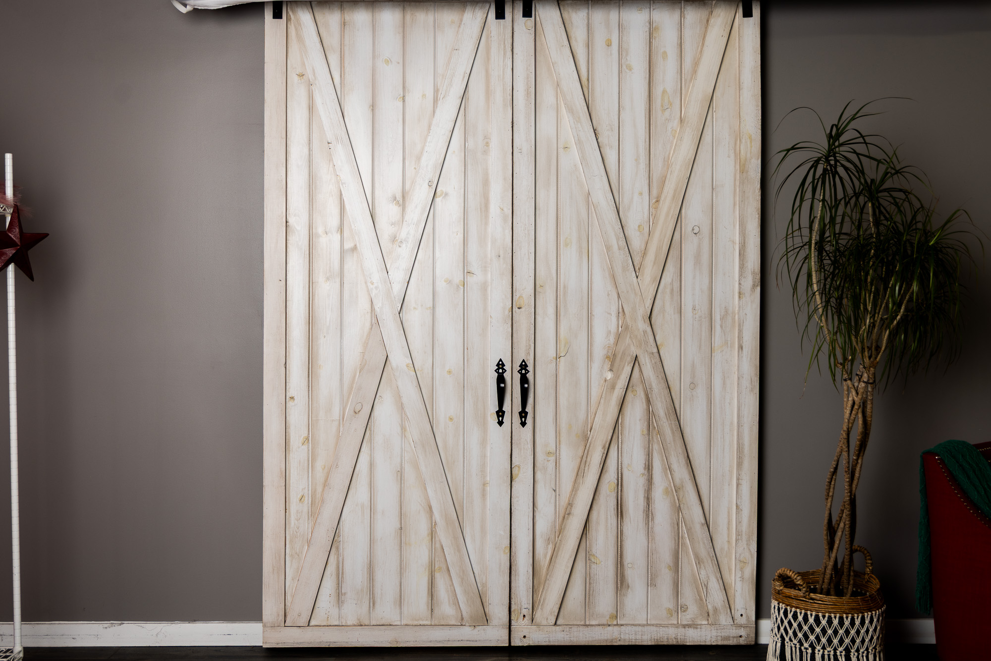 Whitewashed sliding barn doors against a grey wall