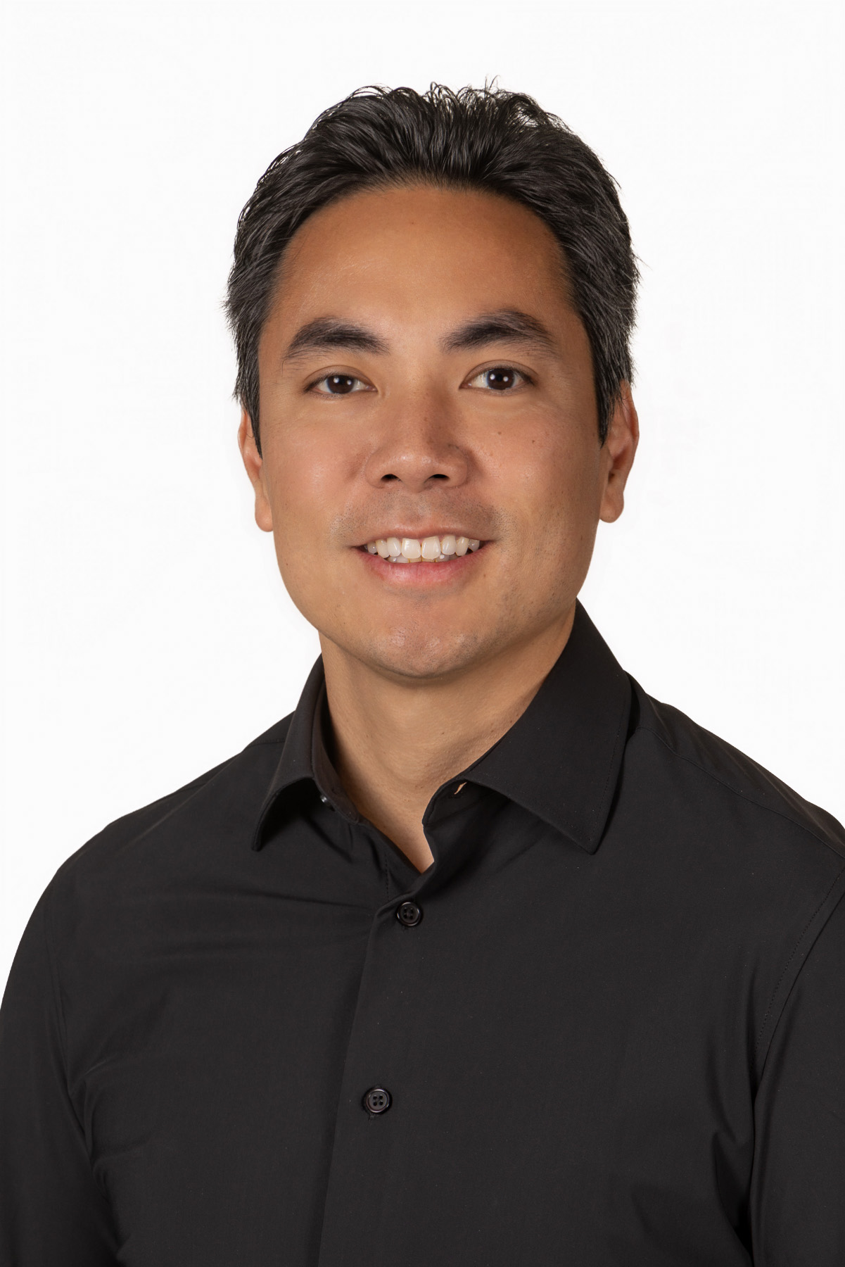 Professional man in a black shirt on a white backdrop